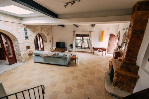 a large living room with a couch and a tv at Private Villa in Naxxar