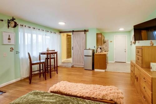 a kitchen with green walls and a table and a refrigerator at Soothing Studio with Lush Views 2 Mi to Beach! in Smith River