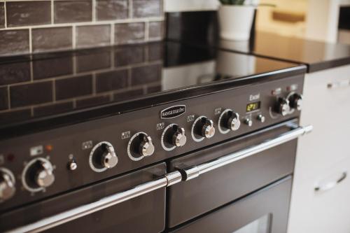 a close up of a stove top oven in a kitchen at Glebe House in Barford Saint Martin
