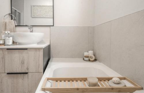 a bathroom with a bath tub and a sink at Tranquil Zen Oasis in Midrand: The Perfect Retreat in Midrand