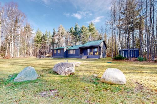 a house with three large rocks in front of it at Grizzly Pines in Jay