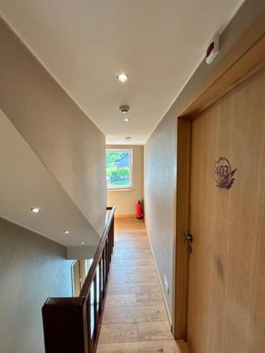 a hallway with a stairway with a stair case at Chez Ninine gite 9 personnes in Stavelot