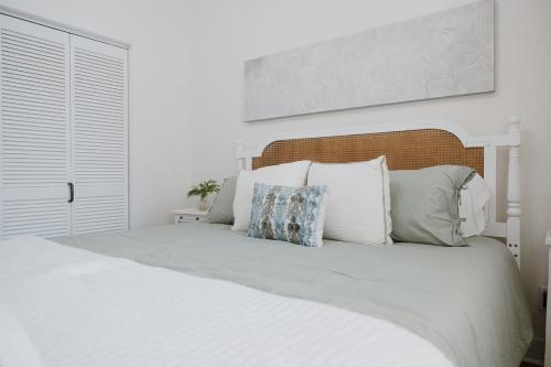 a white bedroom with a white bed with pillows at 29 South by Mira-Mar in Wilmington