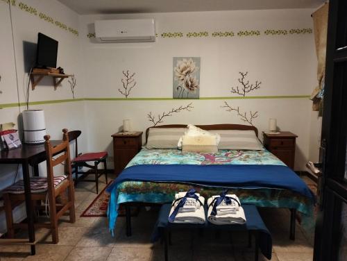 a bedroom with a bed with two pairs of shoes on it at Casa Irene in Torri di Quartesolo