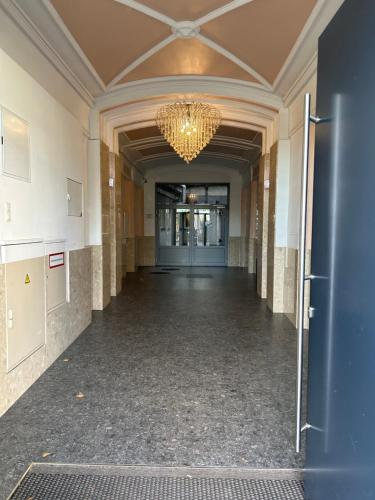 an empty hallway in a building with a chandelier at Vienna Prater Apartment in Vienna
