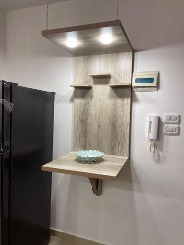 a kitchen with a counter and a black refrigerator at شركة مسايا لشقق المفروشة in Irbid