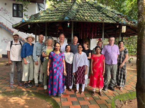 a group of people posing for a picture in front of a building at Marari Beach Villas in Mararikulam