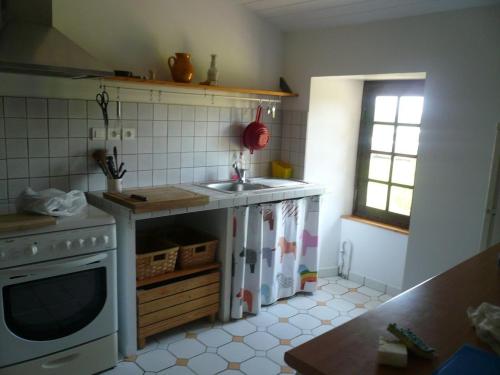 a kitchen with a sink and a stove at Laborde in Mimbaste