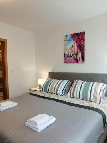 a bedroom with a bed with two towels on it at Sobe pri Roži in Postojna
