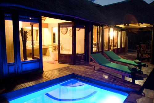 a house with a swimming pool in the yard at Duma Manzi Eco Lodge & Spa in Richmond