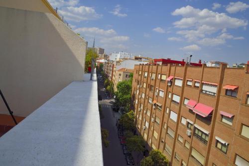 an apartment balcony with a view of a city at Hostal Arrate in Madrid