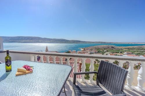 a table and chairs on a balcony with a view of the ocean at Federica in Zubovići