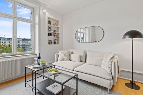 a living room with a couch and a table at NEU - Citywohnung mit Rheinblick in Basel