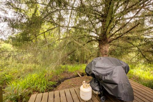 a tent sitting on a wooden deck next to a tree at Brookings Home with Deck, half Mi to Harris Beach! in Brookings