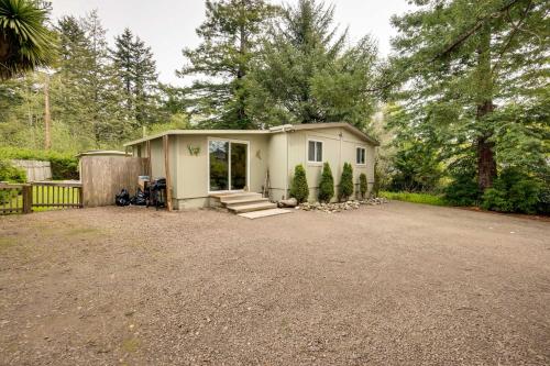 a small house in a yard with a driveway at Brookings Home with Deck, half Mi to Harris Beach! in Brookings
