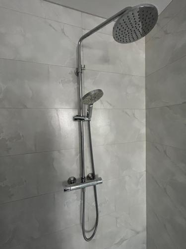 a shower with a shower head in a bathroom at 1 luxurious room in family home in Killarney