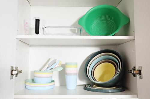 a shelf with plates and dishes in a kitchen at Downtown 3 Queen Beds, AC, Double Garage, Disney in Edmonton