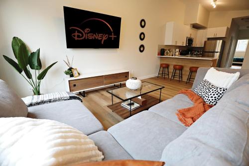 a living room with a couch and a table at Downtown 3 Queen Beds, AC, Double Garage, Disney in Edmonton