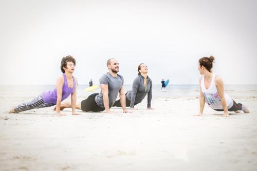a group of people doing yoga on the beach at Beach Motel St. Peter-Ording in Sankt Peter-Ording