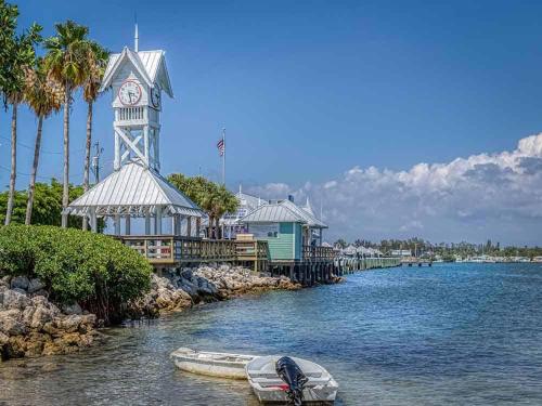 a boat in the water next to a clock tower at All season paradise in Cortez in Bradenton