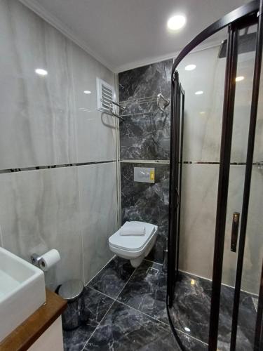 a bathroom with a toilet and a sink and a shower at White Palace Haliç in Istanbul