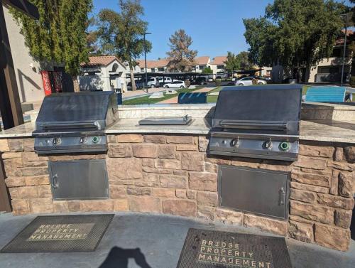 a outdoor grill with two burners on a stone wall at 2 Bed 2 Bath with pool and spa in Phoenix