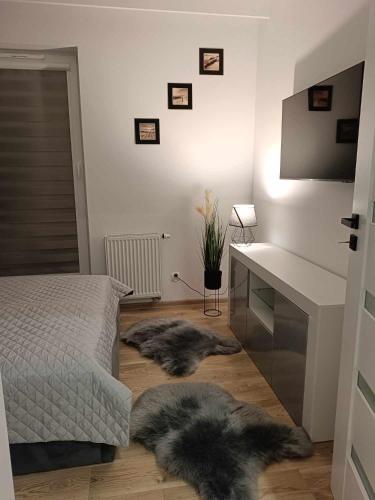 a bedroom with two furry pillows on the floor at Apartamenty Bartoszyce 3 in Bartoszyce