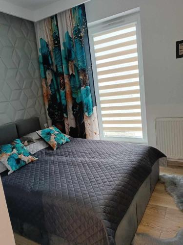 Ένα ή περισσότερα κρεβάτια σε δωμάτιο στο Apartamenty Bartoszyce 3