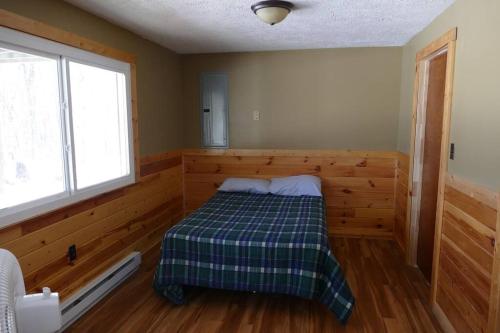 a bedroom with a bed in a room with a window at Mountain Escape @ Deep Creek Lake in Oakland