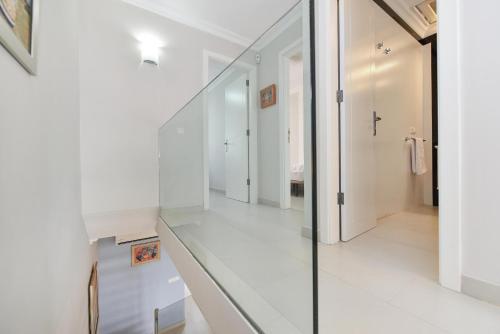 korytarz z białymi ścianami i szklaną podłogą w obiekcie Beachfront Apartment Las Burras MRA 02 w mieście San Agustin