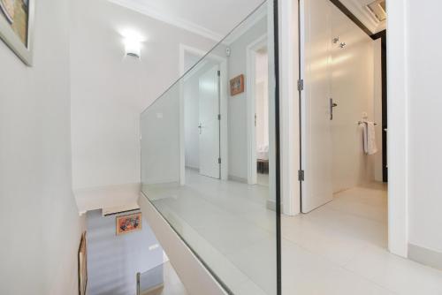 a hallway with white walls and a glass floor at Beachfront Apartment Las Burras MRA 02 in San Agustin