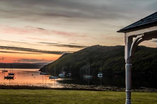 a view of a body of water with boats in it at Shieldaig Lodge Hotel in Gairloch