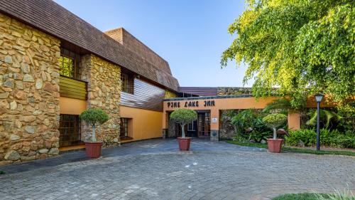 a brick building with a sign that reads funark man at African Sky Hotels - Pine Lake Inn in White River
