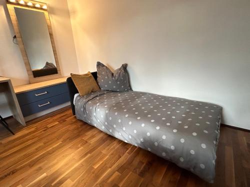 a bedroom with a bed with polka dot sheets at Apartment Wien West in Vienna