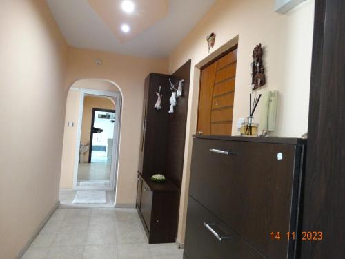 a kitchen with a black refrigerator and a hallway at АЛЕКСАНДРА in Kyustendil