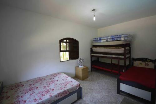 een slaapkamer met 2 stapelbedden en een raam bij Sítio São Francisco Capacidade 30 Pessoas Juquitiba SP in Juquitiba