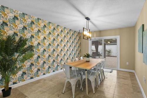 a dining room with a table and chairs and a wall at Tropical Oasis FL Pinellas Park in Pinellas Park