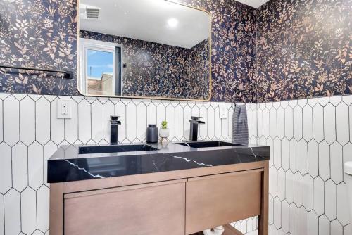 a bathroom with a sink and a mirror at Luxe Penthouse Unit 5, short Walk to Proctors and Dining in Schenectady