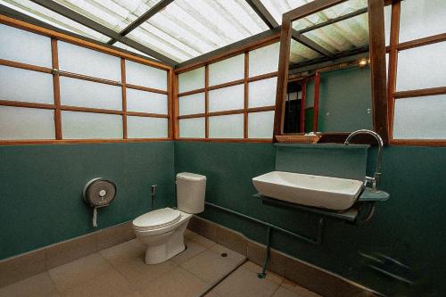 a bathroom with a toilet and a sink at Chiewlan Camp and Resort in Ban Pha Saeng Lang