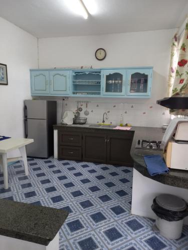 a kitchen with blue cabinets and a blue and white floor at Boisbleu villa in Flic-en-Flac