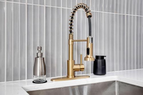 a kitchen sink with a gold faucet at New ElectricCity Junior Penthouse Unit 3, Near Proctors in Schenectady