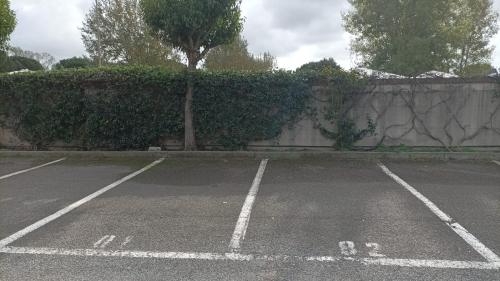 an empty parking lot next to a stone wall at Casa Ricci in Acilia