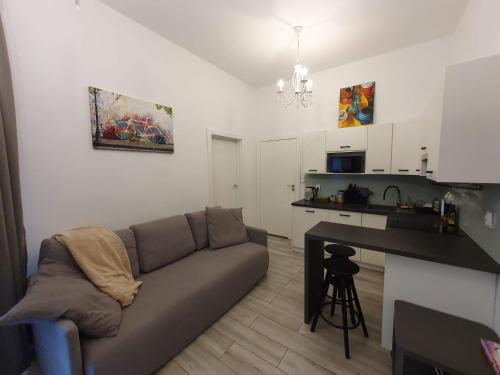 a living room with a couch and a kitchen at Z-1 Kraków Old Town O&P ApartFamily in Kraków