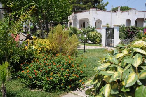 a garden with colorful flowers and a building at B&B Stellamarina in Pulsano