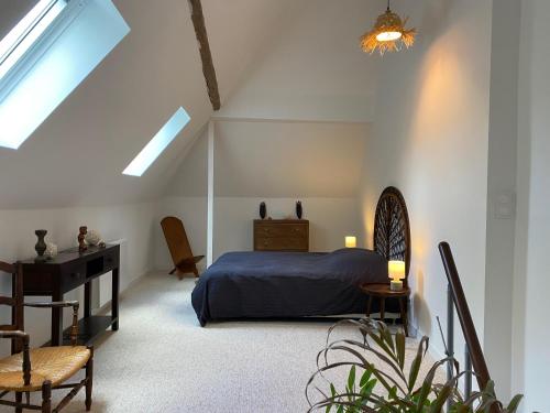 um quarto com uma cama, uma secretária e uma janela em Duplex de charme à Lessy em Lessy