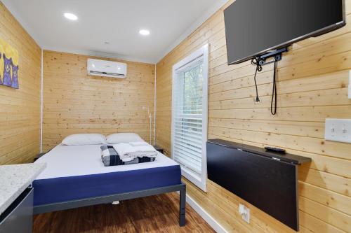 a small room with a bed and a tv at Camptel Poconos in Albrightsville