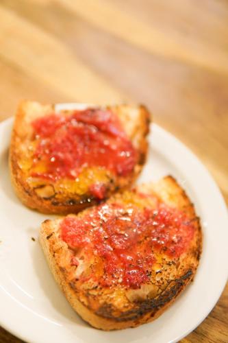 two pieces of toast with sauce on a white plate at Hotel Els Encantats in Espot