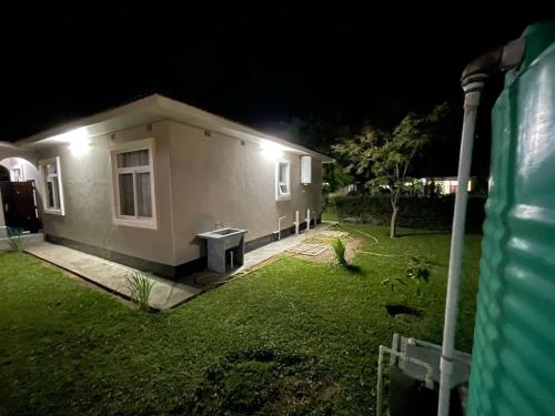 a small house at night with lights on it at Silverest Sanctuary: Home away from Home in Lusaka