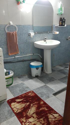 a bathroom with a sink and a toilet and a mirror at Tanger in Tangier