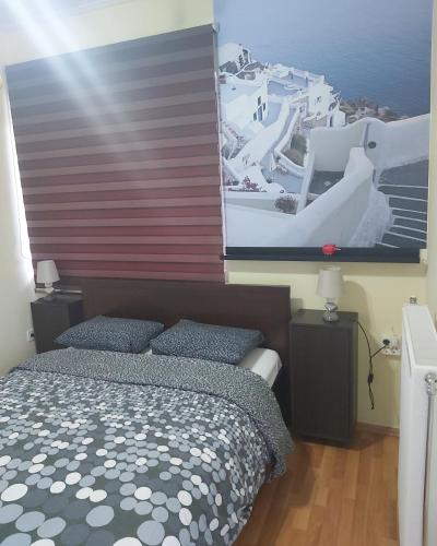 a bedroom with a bed and a large picture on the wall at Daisy luxury in Piraeus